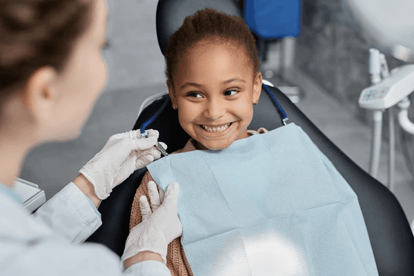Child smiling during a dental visit.